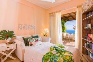 a bedroom with a bed and a view of the ocean at Villa Blue Lagoon in Afitos