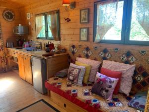 a living room with a couch with pillows on it at La roulotte de Plajoulet in Mirepoix