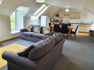 a living room with a couch and a table at Kirkwood - Real Farm Holidays & Experiences in Dalton