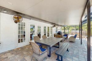 a patio with a wooden table and chairs at Organic Fun in Sarasota