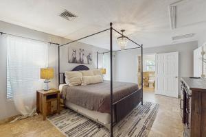 a bedroom with a canopy bed in a room at Organic Fun in Sarasota +18 photos