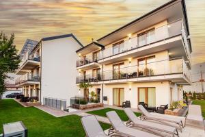 a rendering of an apartment building with lounge chairs at KASHUBIAN Resort in Władysławowo