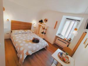 a bedroom with a bed and a table and a window at Calin Apartment in Turin