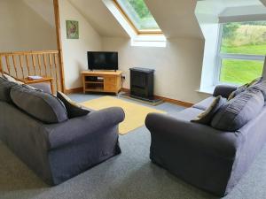 a living room with two couches and a television at Kirkwood - Real Farm Holidays & Experiences in Dalton