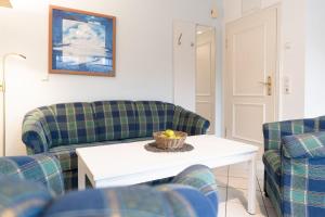 a living room with two couches and a table at Seepferdchen Stüble in Hansaland +29 photos