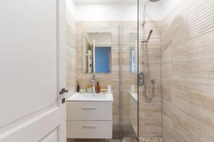 a bathroom with a white sink and a shower at L'Oasis in Marseille +23 photos