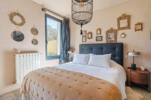 a bedroom with a large bed and a window at L'Oasis in Marseille