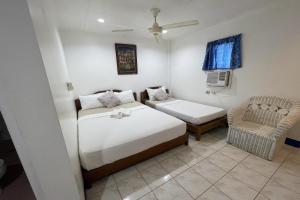 Postel nebo postele na pokoji v ubytování Casa de Praxides Tourist Inn Palawan