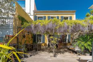 a house with a bunch of wisteria on it at L'Oasis in Marseille