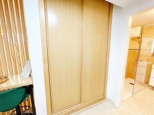 een houten kast in een kamer met een bureau en een stoel bij NEW Tropic Malaka Home in Málaga