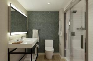 a bathroom with a sink and a toilet and a shower at Marriott Jacksonville Downtown in Jacksonville