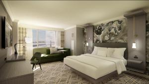 a bedroom with a large bed and a living room at Marriott Jacksonville Downtown in Jacksonville