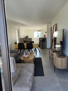 a living room with a couch and a table at Annecy Naila's apartement in Annecy