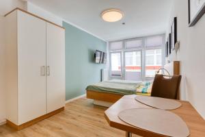 a small room with a table and a bed at Alte Teestube Schmidt 68 in Norderney