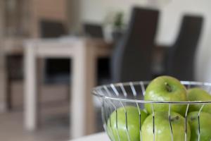 a bowl of green apples sitting on a table at Seestern in Grömitz +22 photos