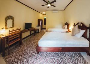 Postel nebo postele na pokoji v ubytování Le Jardin Hotel