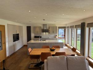a kitchen and dining room with a table and chairs at Danian B&B in Dingwall