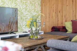 a living room with a table with vases on it at Nienhagen in Nienhagen +37 photos