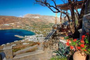 a view of a town and a lake with flowers at Pano Gitonia in Aegiali