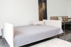 a bed in a room with a white mattress at Strandvilla Augustusbad Meerverliebt in Scharbeutz