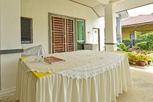 a white table with a book on top of it at Homestay Masha Padang Besar in Padang Besar