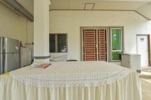 a large white bed in a room with a kitchen at Homestay Masha Padang Besar in Padang Besar +14 photos