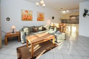 a living room with a couch and a table at Seepark Störtebekers Nest in Scharbeutz