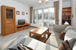 a living room with a couch and a table at Seepark Störtebekers Nest in Scharbeutz