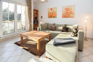 a living room with a couch and a table at Seepark Störtebekers Nest in Scharbeutz