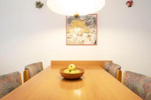 a wooden table with a bowl of apples on it at Kaiserhof 42-44 Meereskrabbe in Kellenhusen +32 photos
