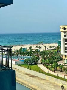 a view of the beach from the balcony of a resort at Luxury apartment Malabata in Tangier