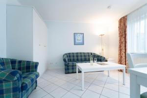 a living room with two couches and a table at Seepferdchen Bargen in Hansaland