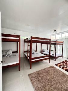 two bunk beds in a room with a rug at GEN B Hotel in Guimbal