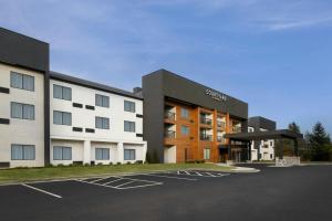 a building with a parking lot in front of it at Courtyard Chesapeake Greenbrier in Chesapeake