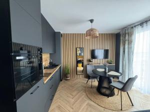 a kitchen with a table and a dining room at Travel Apartament Płock in Płock