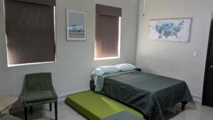 a hospital room with a bed and a chair at DGMLoftsTEC comodo zona sur MTY in Monterrey