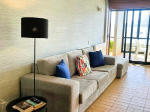 a living room with a couch and a lamp at Casa Foz do Rio in Caminha