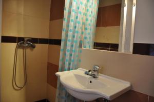 a bathroom with a sink and a shower at Wymój Park in Stawiguda +33 photos