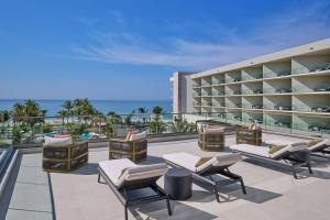 a resort with lounge chairs and the ocean in the background at The St. Regis Longboat Key Resort in Longboat Key