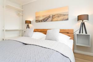 a bedroom with a bed with a wooden headboard at Sandberger Weg 62 Oberdeck in Neustadt in Holstein