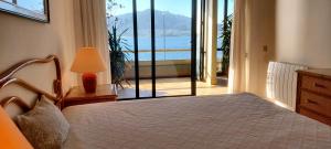 a bedroom with a bed and a view of the ocean at Casa Foz do Rio in Caminha