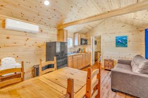 a living room and kitchen in a log cabin at Aqua Lodges at 47th Street in Marathon