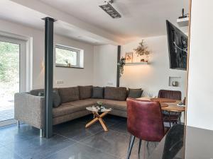 a living room with a couch and a table at Geschäfts- und Monteurs Apartment 2 SZ in Königswinter