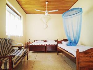 En eller flere senge i et værelse på Mallika Guest House