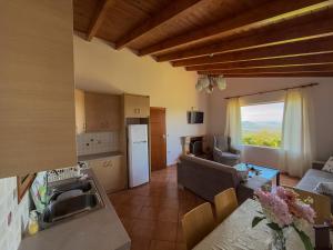 a kitchen and living room with a couch and a table at SunView Villa in Kostar