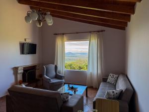 a living room with a couch and a large window at SunView Villa in Kostar