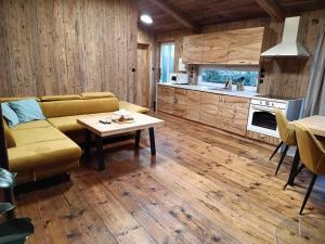a living room with a couch and a table at WoodhouseOld in Červená Voda
