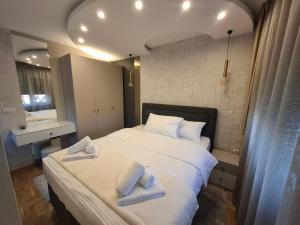 a bedroom with a bed with two towels on it at Astera 3 in Vrnjci