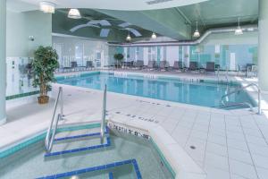 a large swimming pool in a building at Residence Inn by Marriott Moncton in Moncton