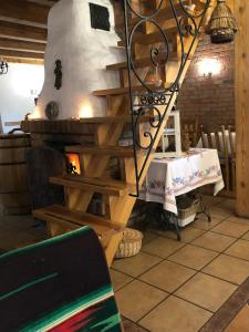 a room with a table and a spiral staircase at Dworek Szyszki - Kaszuby in Liniewko